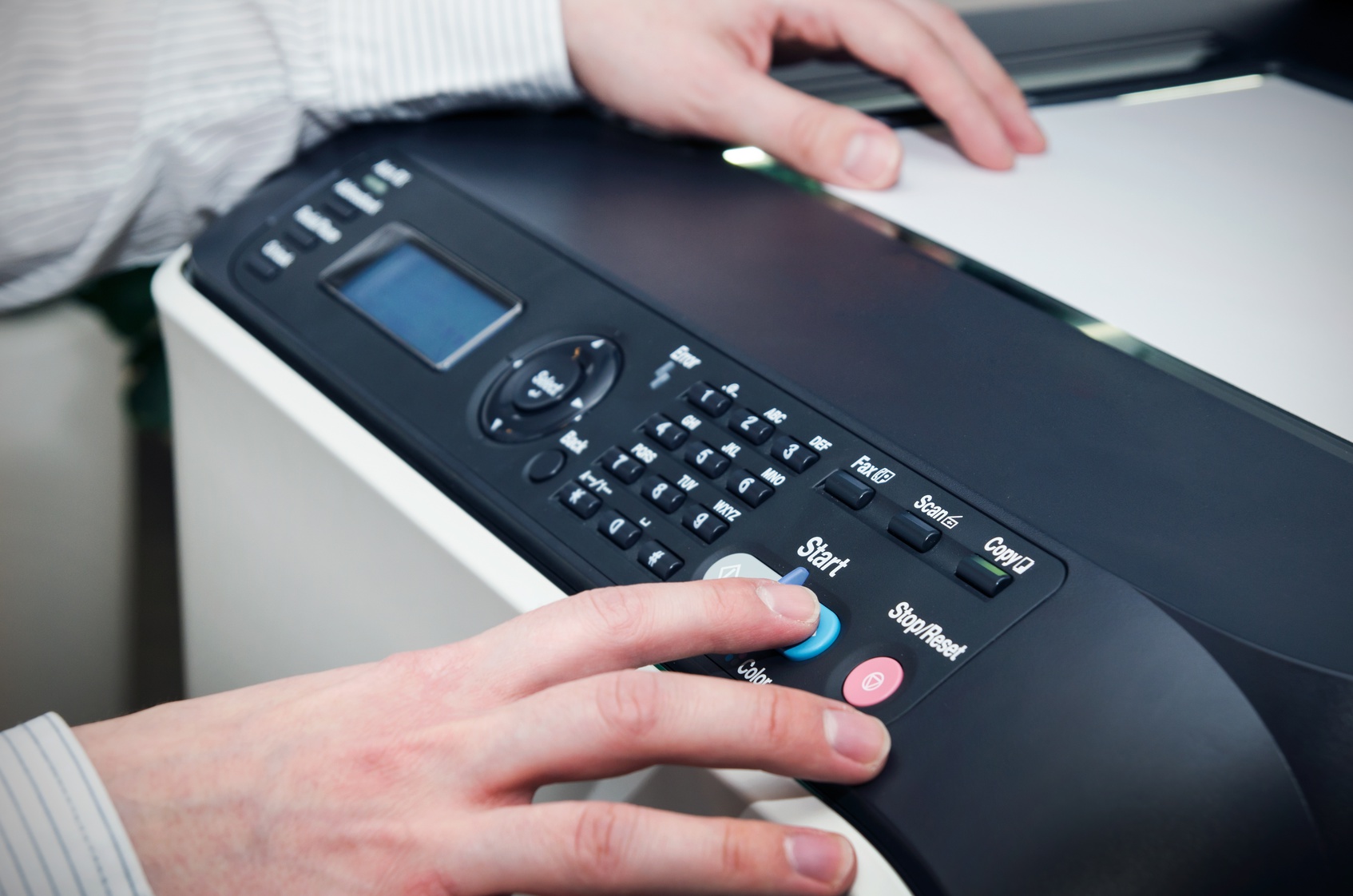 Man using scanner multifunction device in office